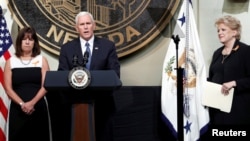 U.S. Vice President Mike Pence is joined by his wife, Karen, left, and Las Vegas Mayor Carolyn Goodman as he speaks in Las Vegas City Hall following a Unity Prayer Walk in Las Vegas, Nev., Oct. 7, 2017.