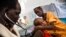 FILE - A doctor examines a boy with tuberculosis at the hospital of Doctors Without Borders in Malakal, South Sudan, June 15, 2016.