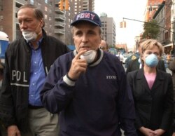 FILE - New York City Mayor Rudolph Giuliani leads New York Gov. George Pataki, left, and Sen. Hillary Clinton, D-N.Y., on a tour of the site of the World Trade Center disaster, Sept. 12, 2001.