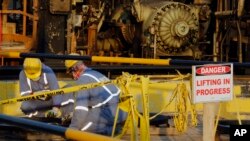 During a trip organized by Saudi information ministry, workers fix the damage in Aramco's oil processing facility after the recent Sept. 14 attack in Abqaiq, near Dammam in the Kingdom's Eastern Province, Sept. 20, 2019. 
