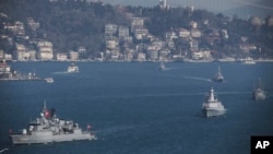 FILE - Turkish Navy vessels cross the Bosporus Strait in Istanbul, March 9, 2019, upon completion of massive military drills. A joint naval drill between Russia and Turkey last Friday in the Black Sea was part of Turkey's broader military exercise.