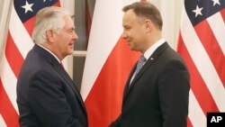 U.S. Secretary of State Rex Tillerson shakes hands with Polish President Andrzej Duda, during a visit to Warsaw, Poland, Jan. 26, 2018. 