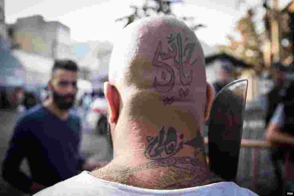 Some Shia mark their faith through tattoos. Tthis one pays tribute to Hussein, grandson of the Prophet Muhammad. (J. Owens/VOA)