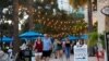 FILE - People walk without masks on Beach Drive in downtown St. Petersburg, Florida, amid the coronavirus pandemic, Aug. 6, 2021. 