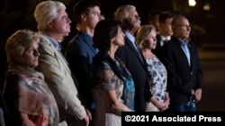 Family members of American citizens killed in Syria by members of an Islamic State group stand before the news media following a hearing at the U.S. Courthouse in Alexandria, Va., Sept. 2, 2021. 