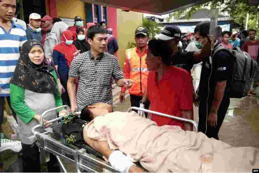 A survivor receives medical treatment at a hospital in Carita, Dec. 23, 2018, after the area was hit by a tsunami Saturday following an eruption of the Anak Krakatoa volcano.