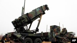 A camouflaged convoy of Dutch military trucks carrying two batteries of Patriot missiles is lined up for a media opportunity before departing De Peel Air Base in Vreedepeel, southern Netherlands, Jan. 7, 2013.