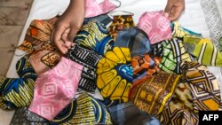 FILE - Handmade face masks made from African fabric are seen in Yaoundé, April 23, 2020. Police are arresting Cameroonians not wearing protective face masks to protect against COVID-19.