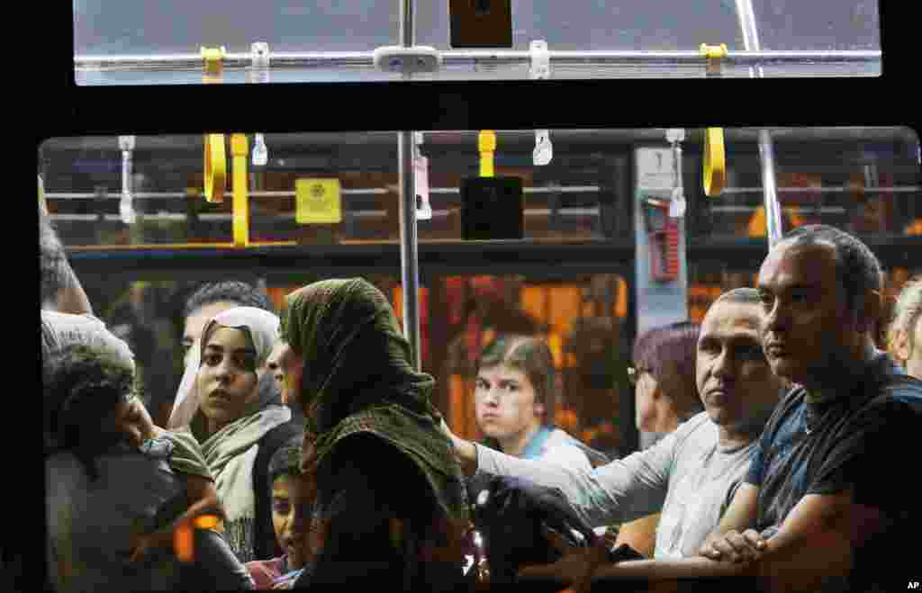 Following their evacuation after a series of explosions, a flight's passengers leave on a bus from Istanbul's Ataturk airport in the early-morning hours of June 29, 2016.