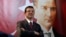 Backdropped by a poster of modern Turkey's founder, Mustafa Kemal Ataturk, Ekrem Imamoglu, the Republican People's Party's mayoral candidate in Istanbul, poses following an interview in Istanbul, April 4, 2019. 