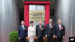 FILE - Hong Kong security chief Zheng Yanxiong, right, attends his office's opening, July 8, 2020. With him, from left, are liaison office director Luo Huining; Chief Executive Carrie Lam; and two of her predecessors, Tung Chee-hwa and Leung Chun-ying.