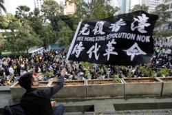 A pro-democracy supporter waves a flag during a rally by the advertising industry in Hong Kong, Dec. 2, 2019.