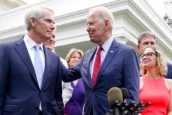 President Joe Biden speaks with Sen. Rob Portman, R-Ohio, and other bipartisan group of senators, outside the White House in Washington, June 24, 2021.