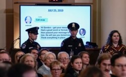 A text message between Ambassador Kurt Volker, former special envoy to Ukraine, and Gordon Sondland, ambassador to the European Union, is displayed as the House Intelligence Committee holds a hearing on Capitol Hill in Washington, Nov. 19, 2019.