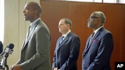 Missouri Department of Public Safety director Daniel Isom, left, speaks as St. Louis Mayor Francis Slay, center, and St. Louis County Executive Charlie A. Dooley listen during a news conference, Nov. 21, 2014, in Clayton, Mo. 