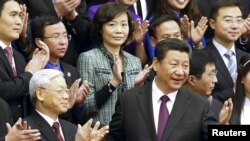 ប្រធានាធិបតី​ចិន​លោក​ ​ស៊ី ​ជីង​ពីង​ (ស្តាំ)​ និង​លោក Nguyen Phu Trong ​មេដឹកនាំ​គណបក្ស​កុម្មុយនិស្ត​វៀត​ណាម​ (ឆ្វេង) ឈរ​ថត​រូប​ជាមួយ​ក្រុម​យុវជន​ចិន​និង​វៀតណាម​នៅ​ឯ​វិមាន​ Great Hall of the People ​ក្នុង​ក្រុង​ប៉េកាំង​ កាល​ពី​ថ្ងៃ​ទី​៧​ ខែ​មេសា​ ឆ្នាំ​២០១៥​។