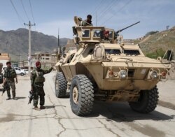 FILE - Afghan National Army soldiers keep watch at the site of a suicide attack in Kabul, Afghanistan, April 29, 2020.