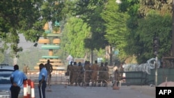 Military personnel stand outside the headquarters of the country's defence forces in Ouagadougou on March 3, 2018 a day after dozen of people were killed in twin attacks on the French Embassy and the country's military.