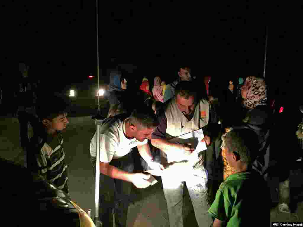 Newly arrived Iraqis from Fallujah in the early morning of 25 May 2016, being received by NRC staff.