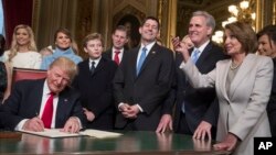 President Donald Trump is joined by the Congressional leadership and his family as he formally signs his cabinet nominations into law, in the President's Room of the Senate, at the Capitol in Washington, Jan. 20, 2017. 