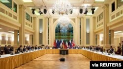 European External Action Service (EEAS) Deputy Secretary General Enrique Mora and Iranian Deputy at Ministry of Foreign Affairs Abbas Araghchi wait for the start of a meeting of the JCPOA Joint Commission in Vienna, Austria, April 6, 2021. 