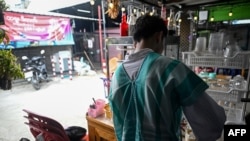 This photo taken on June 4, 2024 shows "Wai Yan," a former student and member of the Civil Disobedience Movement (CDM), making drinks at a restaurant after fleeing from Myanmar to Thailand to avoid conscription by Myanmar's military junta, in Bangkok.