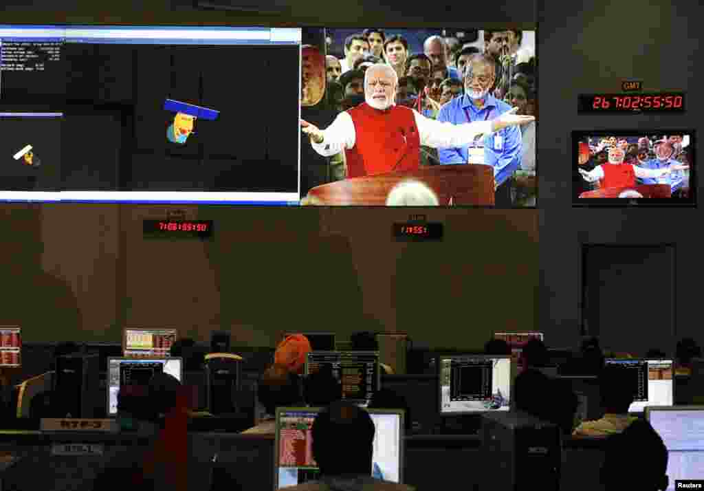 Indian Space Research Organization scientists and engineers watch Prime Minister Narendra Modi on screens after India&#39;s satellite successfully entered Mars&#39; orbit, at the Spacecraft Control Center, in the southern Indian city of Bangalore, Sept. 24, 2014. 