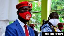 FILE - Ugandan musician turned politician, Robert Kyagulanyi, left, also known as Bobi Wine, and Uganda's four-time Presidential candidate Kizza Besigye attend a joint news conference in Kampala.