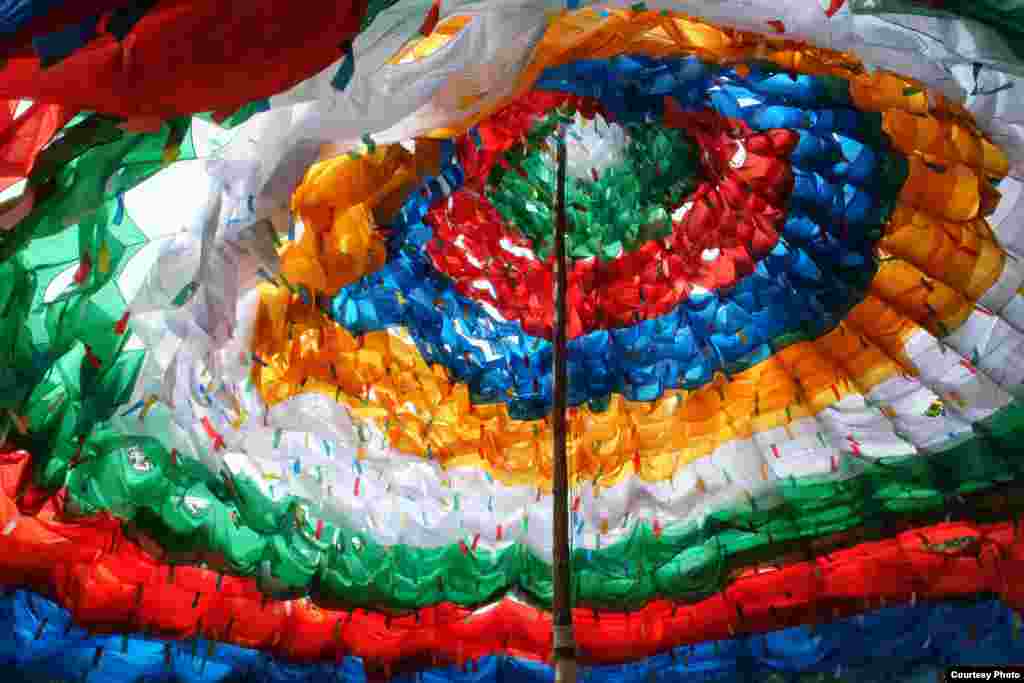 An estimated 1,000 Tibetan prayer flags flutter in the wind as they form the shape of a giant pagoda at Khadiravana Center, Hua Hin, Thailand&#39;s only institution dedicated to the teaching and learning of Tibetan Buddhism and the art and culture of Tibet and the Himalayas, July 6, 2014. (Photo taken by Matthew Richards/VOA reader)