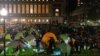 TOPSHOT - NYPD officers in riot gear enter Columbia University's encampment as they evict a building that had been barricaded by pro-Palestinian student protesters in New York City on April 30, 2024.
