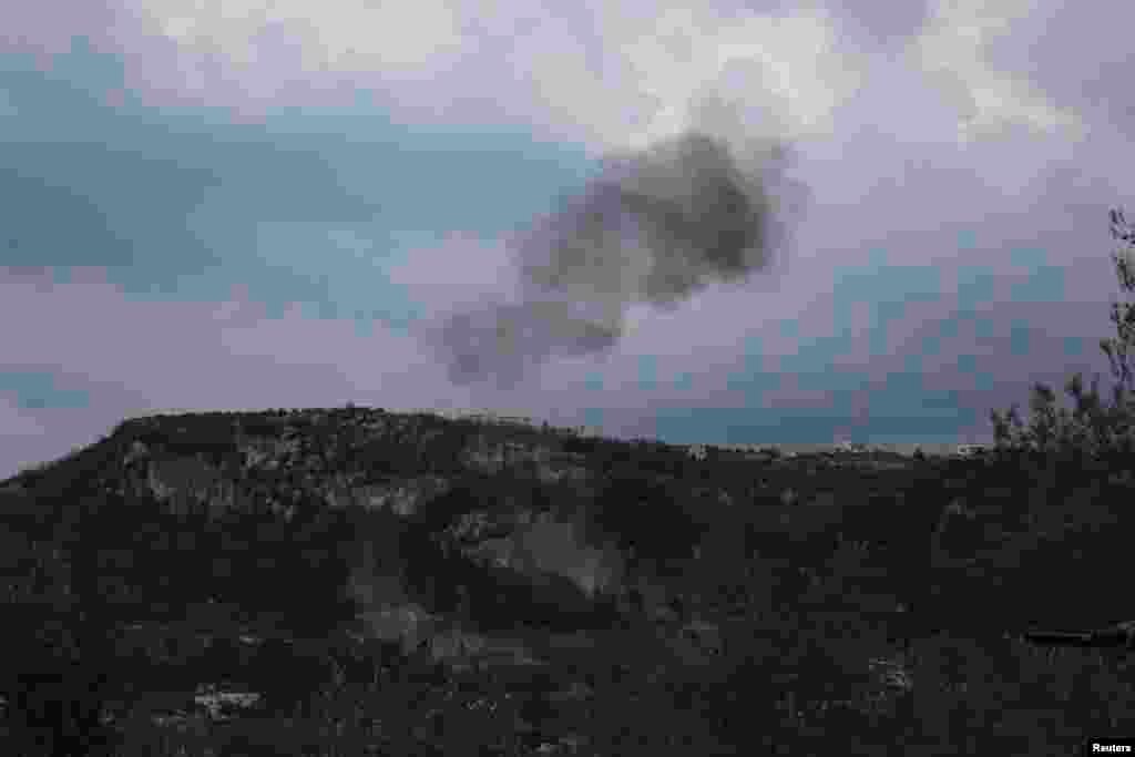 Smoke rises from what activists said were explosive barrels thrown by forces loyal to Syria's President Bashar al-Assad in Jabal al-Akrad, Latakia, Jan. 20, 2014.