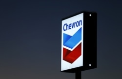 FILE - A Chevron gas station sign is shown in Cardiff, California, Jan. 25, 2016.