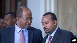 FILE - Tagesse Chafo Speaker of House of Representative, left, and Ethiopian Prime Minister Abiy Ahmed, right, leaving the parliament after addressing members of parliament.