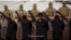 FILE - Militants from the so-called Islamic State stand behind what are said to be Ethiopian Christians in Libya, in this still image from an undated video posted to a social media website on April 19, 2015.