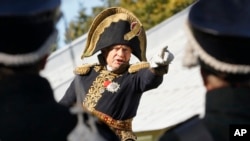 FILE - Oleg Sokolov, a history professor at St. Petersburg State University, wears a 1812-era French army general's uniforms during a staged battle re-enactment to mark the 200th anniversary of the battle of Borodino, Sept. 16, 2012.