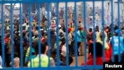FILE - Congolese people gather at the United Nations High Commission for Refugees’ Kyangwali refugee settlement camp, Uganda, March 19, 2018.