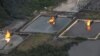 FILE - A gas flare at Shell Cawtharine Channel, Nembe Creek in the Niger Delta. 