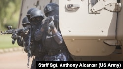 A Burkinabe police officer with the Special Intervention Unit fires his AK-47 rifle during a simulated terrorist attack as part of exercise Flintlock 2019 in Ouagadougou, Burkina Faso, Feb. 27, 2019. 