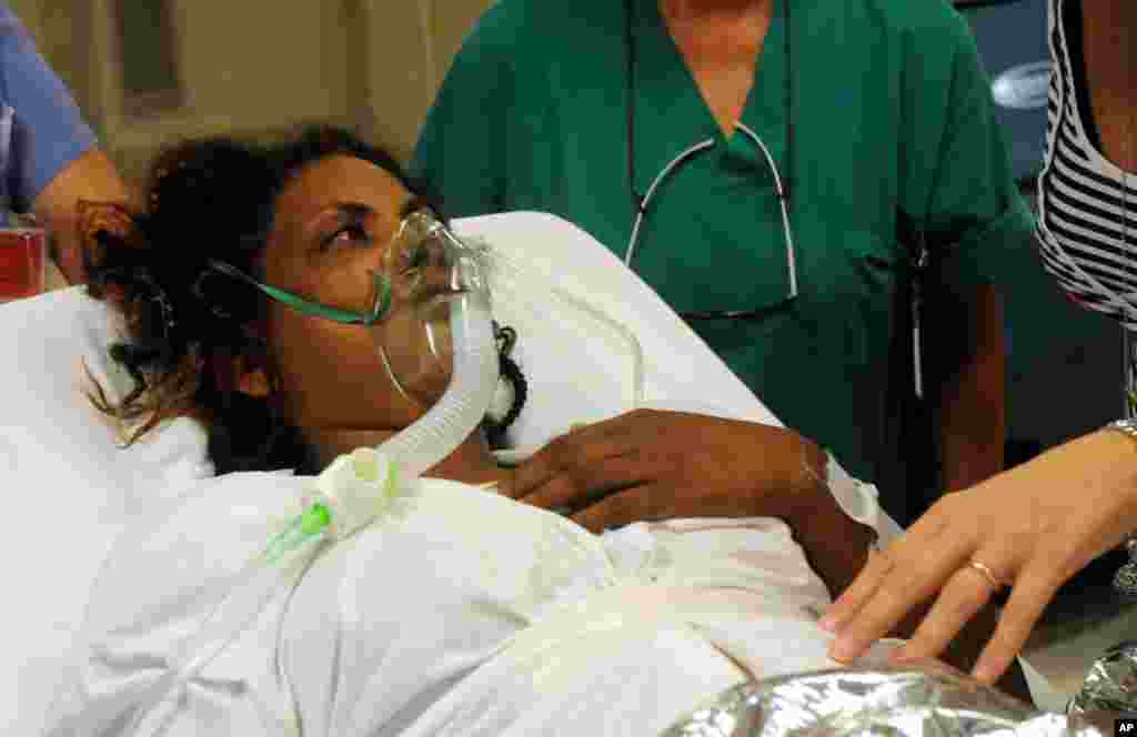 A woman receives assistance at the Palermo Civico hospital after being rescued off the Italian island of Lampedusa, Oct. 3, 2013. 