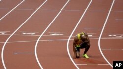FILE - A sprinter is seen resting after a 100-meter race.
