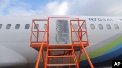 FILE - This image taken Jan. 7, 2024, and released by the U.S. National Transportation Safety Board, shows a section of the Boeing 737 Max 9 that lost a panel in flight, in Portland, Oregon. Boeing said on Feb. 21 that it was replacing the head of the 737 MAX program immediately.