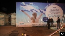Israeli police officers inspect the scene of an attack in Jerusalem, early Thursday, Feb. 6, 2020, after a Palestinian motorist slammed his car into a group of Israeli soldiers.