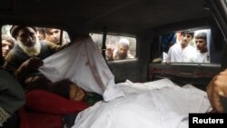 Afghan villagers look at the bodies of women allegedly killed by NATO air strikes in Laghman province September 16, 2012.