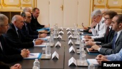 French Interior Minister Gerard Collomb (2ndL) heads a staff meeting the day after a man killed a passer-by in a knife attack in the heart of Paris and injured four others before being shot dead by police, in Paris, May 13, 2018. 