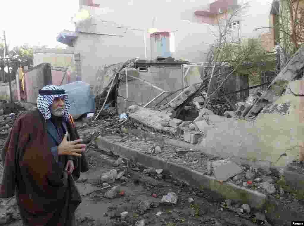 A man surveys the site of a car bomb attack north of Baghdad, Jan. 20, 2014.