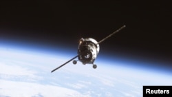 FILE - With the Earth's horizon in the background, an unmanned Progress supply ship approaches the International Space Station in this undated photograph.