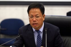 FILE - Xu Guixiang, the deputy propaganda head of the Xinjiang Uyghur Autonomous Region for China's Communist Party, speaks during a press conference at the Ministry of Foreign Affairs in Beijing, March 18, 2021.