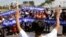 A leader, foreground, of Cambodian activists controls the group to pay respects in front of Royal Palace during a march toward the National Assembly, in Phnom Penh, file photo. 