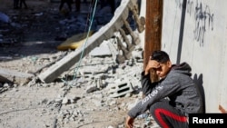 A Palestinian boy reacts near the site of an Israeli strike on a house, in Rafah, in the southern Gaza Strip