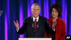 Senate Minority Leader Mitch McConnell, joined by his wife, former Labor Secretary Elaine Chao, celebrates with his supporters at an election night party in Louisville, Ky., Nov. 4, 2014. 